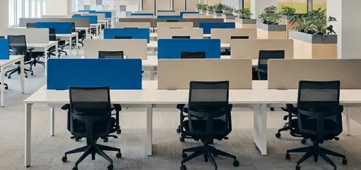 Modern open-plan office space featuring clean workstations, ergonomic chairs, and sanitized carpets provided by professional office cleaning services in Stockton, CA.