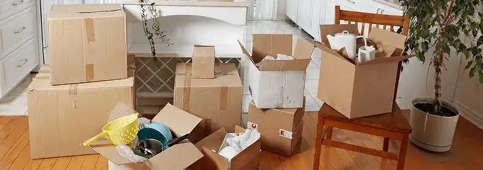 Packed moving boxes and household items in a kitchen before move-out or move-in cleaning, Stockton, CA.
